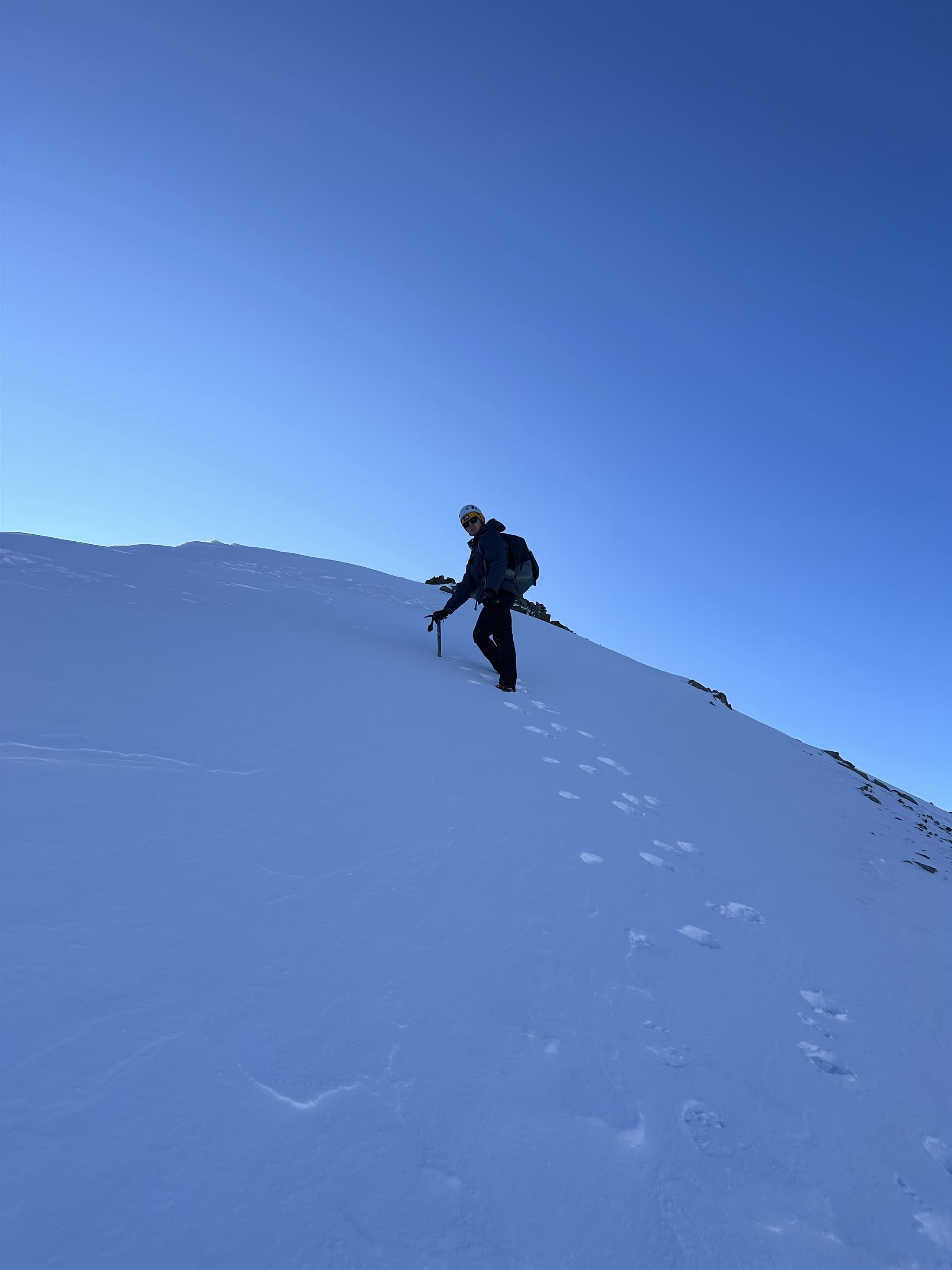 Maxwell Bennett on a snow ridge during an alpine mountaineering course