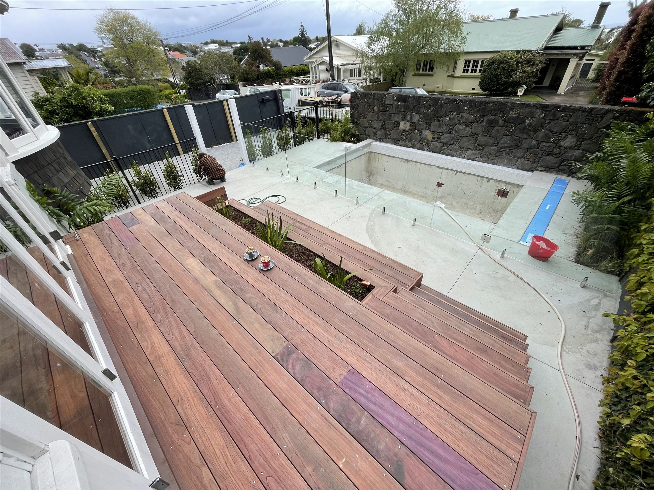 The same Auckland property on handover, new deck, pool and glass balustrade