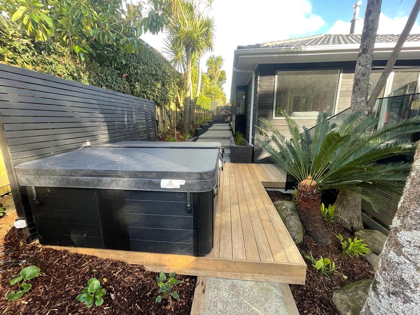 Completed Auckland landscaping project with spa, deck and planting